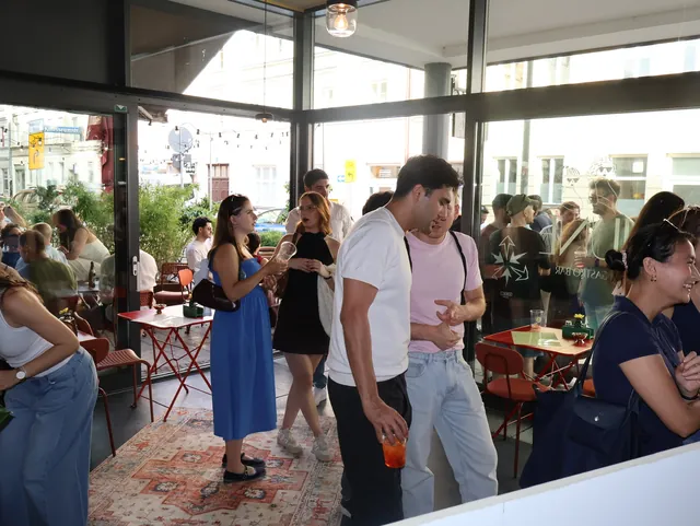 Guests talking in the sunlit JUNE bar
