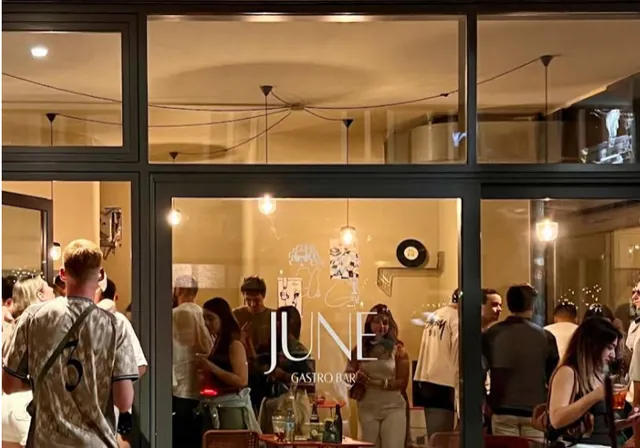 JUNE’s illuminated storefront at night